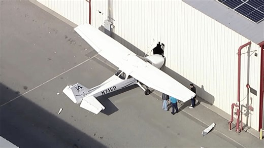 Suspect steals plane from flight school, crashes into building at popular airport: police