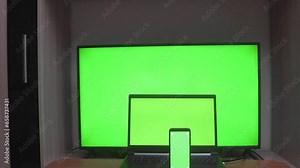 Laptop, mobile phone and HDTV with chromakey screens, with copy space. Green screen concept for product presentation, online orders