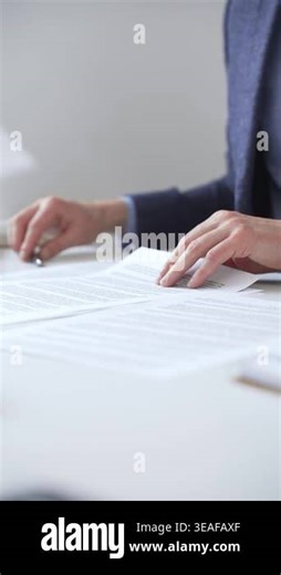Close up of businessmans hands holding and reviewing a contract during an office meeting, preparing to sign an important business agreement. Business people concept Stock Video Footage - Alamy