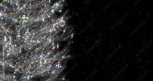 Rotating silver Christmas tree with decorations and sparkling multi-colored garland close-up. Falling snow on a dark background. Seamless looping animation.