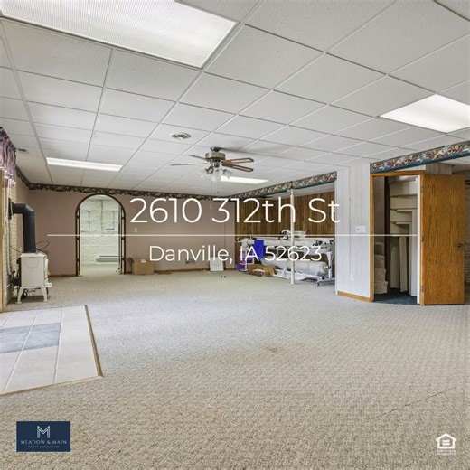 Tucked away on approximately 18 wooded acres in Danville, Iowa, this beautifully crafted, full brick exterior, ranch-style home offers privacy, quality construction, and exceptional versatility. Surrounded by natural views, the setting feels secluded while still providing the comfort of a thoughtfully designed home andan impressive shop building ready for work or play. The main level features an open-concept kitchen and living area with vaulted ceilings, skylights, and abundant natural light. Cu