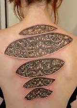 Photos of Tattoos That Look Like Wood Carvings