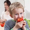 Healthy Family Eating Tomato