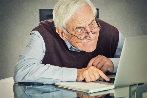 man sitting on table using computer