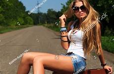 hitchhiking along pretty road woman young shutterstock stock search