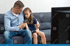 daughter father upset sitting gamepads sofa