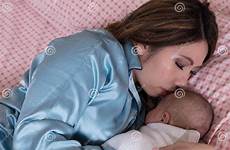bed son mom sleeping infant closely holding her while mother young preview