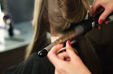hair hairdresser doing curling salon blond curls proffesional iron close beauty girls