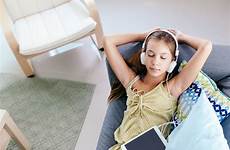 tween couch girl relaxing chilling headphones fotolia preview