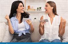 girls playing games two gesturing phones sitting indoor yes preview