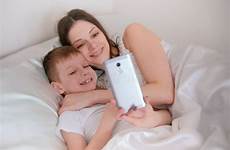 son mom her bed selfie mobile phone take sleeping morning together hugging
