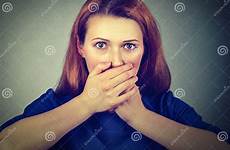 scared mouth covering hands woman her