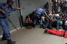 africa south police riots riot brutal migrant suspects arrest detain protests afp getty