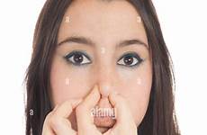 nose holding woman her background stock alamy smelly isolated close