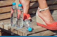 bench legs water bottles young girl preview