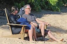 beach wife brosnan pierce hawaii keely shaye smith enjoys exclusive his stretched swim toweled sand actor playing legs feet off