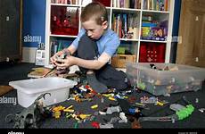 toys away tidying boy his bedroom young alamy stock