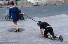 leash dog woman man china walks walk male her shocking takes boy public around streets fuzhou traffic