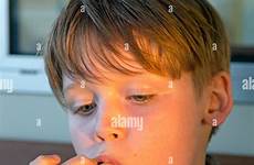 boy licking fingers his young alamy stock