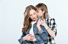 lesbian couple hugging posing isolated together young blue stock