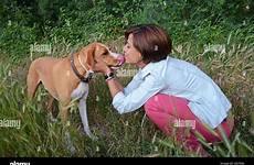 dog woman kissing tongue kiss alamy stock young