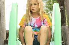 little girl slide sitting barefoot dreamstime shirt feet green smiling preview