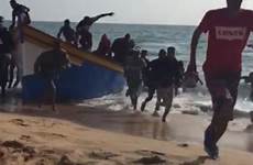 migrants onto shock landed immigrants tourists astounded holidaymakers lying