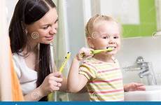 brushing teeth teaching child mom stock girl