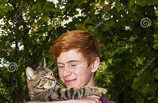 cat teen boy holding tabby outside garden his stock