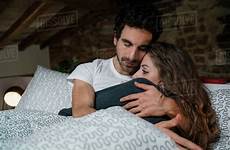 couple bed romantic lying hugging dissolve stock cultura d943