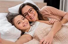 mother selfie daughter bed together taking