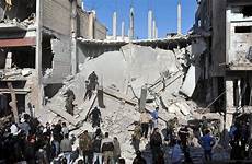 homs bombing syrian wsj syrians attacks rubble neighborhood kills syria bombings zahra