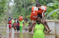 kerala india rescue flood operation children floods indian displace over shoulders during deadly fire bodies climate state cities extreme damage