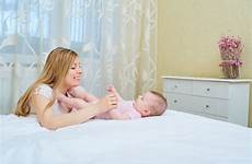 her smiles playing mother child mom bed baby preview indoor