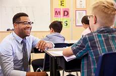 student teacher teaching students elementary teachers education college school smiling university desk beside columbia office