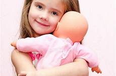doll holding girl little her cute embracing preview