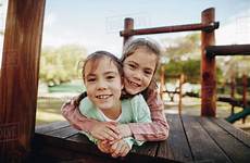 hugging girl little sister girls her play lying twin wooden while playground enjoying structure park beautiful dissolve stock lund jacob