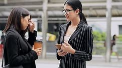 Young generation business team not working together concept. Young business intern Asian woman having very serious fight and arguments with her Asian female manager, dramatic expression. Medium shot.