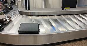 Premium stock video - An airport baggage carousel in the arrivals hall