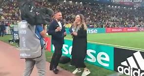 Presenter Emma Saunders dances on the sideline of England game