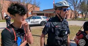 An activist chases a man around outside York Mills Collegiate then yells at Caryma while Toronto Police stand back and watch.