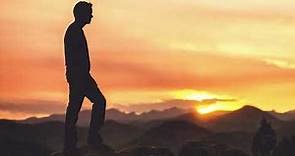 Man Silhouette In Thought Standing On Mountaintop With Sunrise Or Sunset 4K Christian Worship Loop