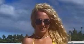 Britney nearly suffers wardrobe malfunction in very tiny yellow bikini on beach
