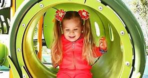Little girl Diana have fun playing on the Outdoor playground, Kids video