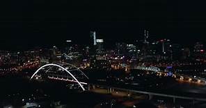 Orbiting aerial of downtown Nashville Tennessee city skyline at night, Drone 4K