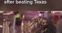 Alabama players throw "horns down" after beating Texas
