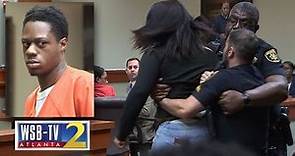 WATCH: Murder victim's teen daughter lunges at accused killer, removed from courtroom | WSB-TV