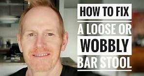 A professional actor fixes a loose or wobbly metal bar stool