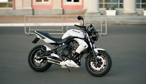a white and black motorcycle parked in front of a building