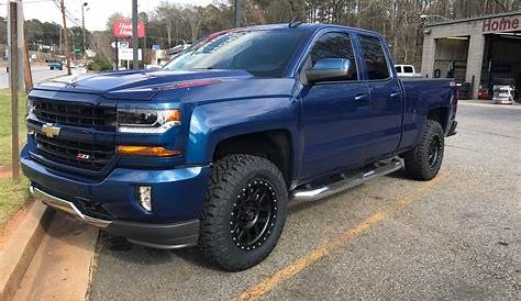 blue chevy silverado with black rims